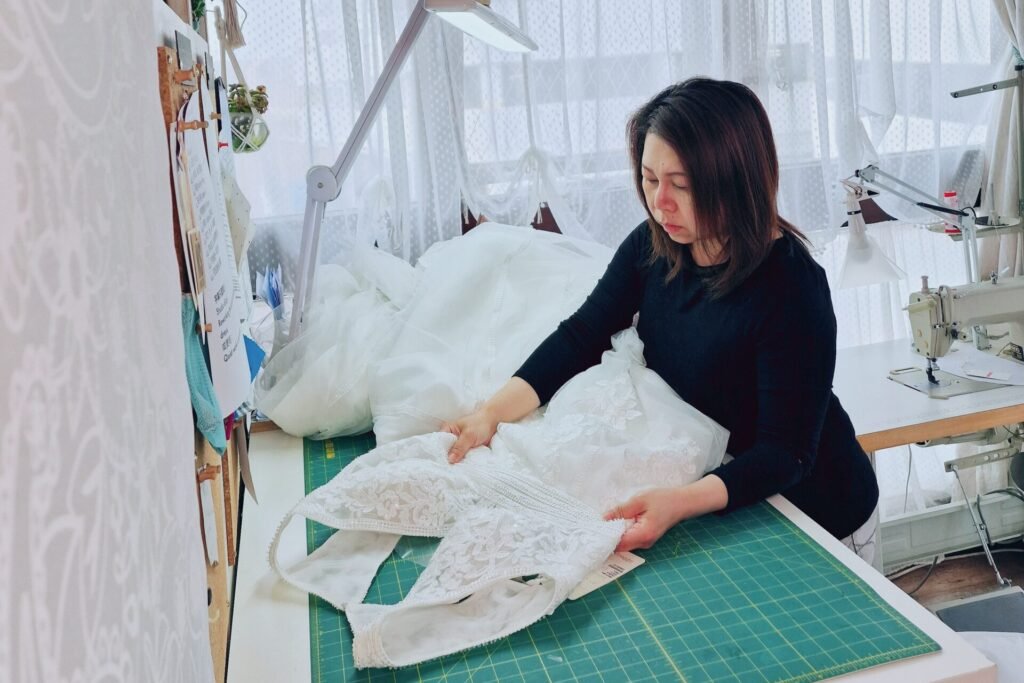 Nikki working on bridal gown alteration at SUU Bespoke