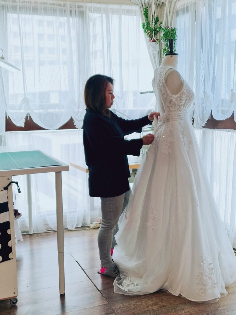 Nikki working on bridal gown alteration at SUU Bespoke